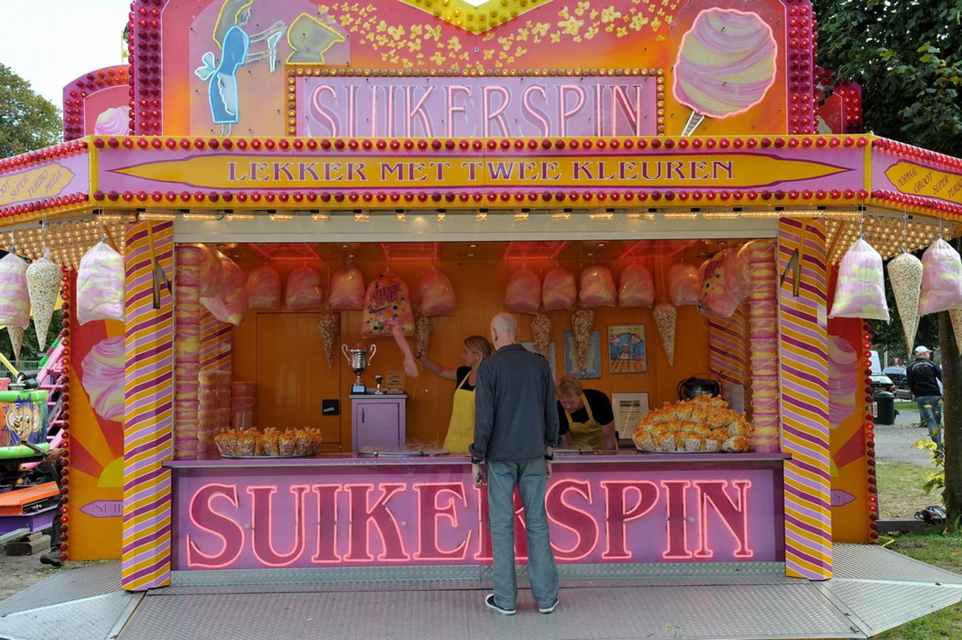 Kleurrijke snoepkraam met suikerspinnen en schuimzakken op de Haagse kermis